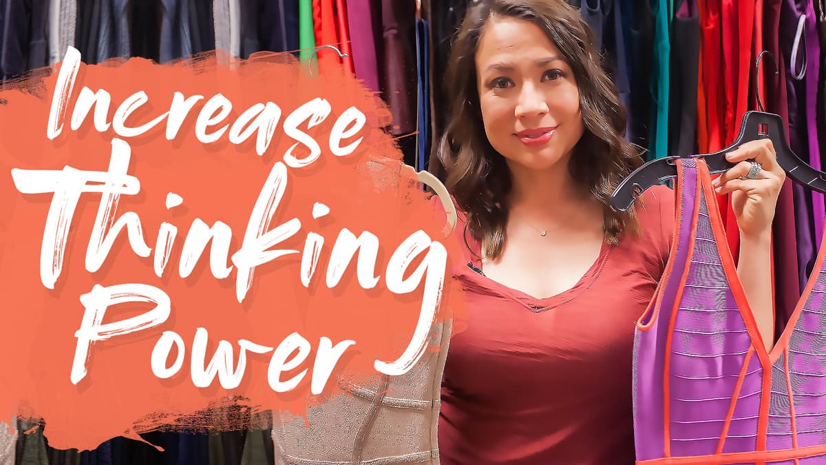 A woman in a red shirt holds up two dresses in a colorful clothing store. The text over the image reads, Increase Thinking Power. The background features a variety of hanging clothes.