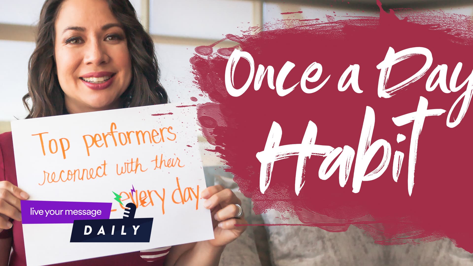 A woman holds a sign that reads, Top performers reconnect with their ______ every day. The background has text saying, Once a Day Habit, with a paint-like design and a logo at the bottom left corner.