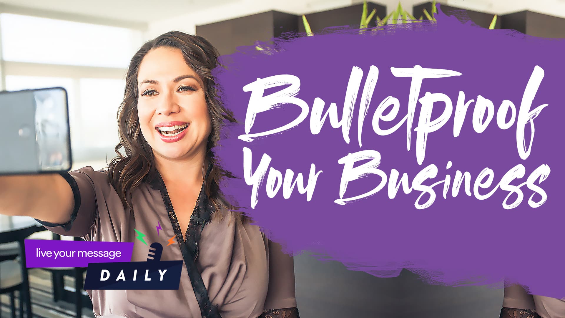 A woman is taking a selfie, smiling. The text beside her reads Bulletproof Your Business. A small logo in the corner says Live Your Message Daily. The background includes plants and modern decor.