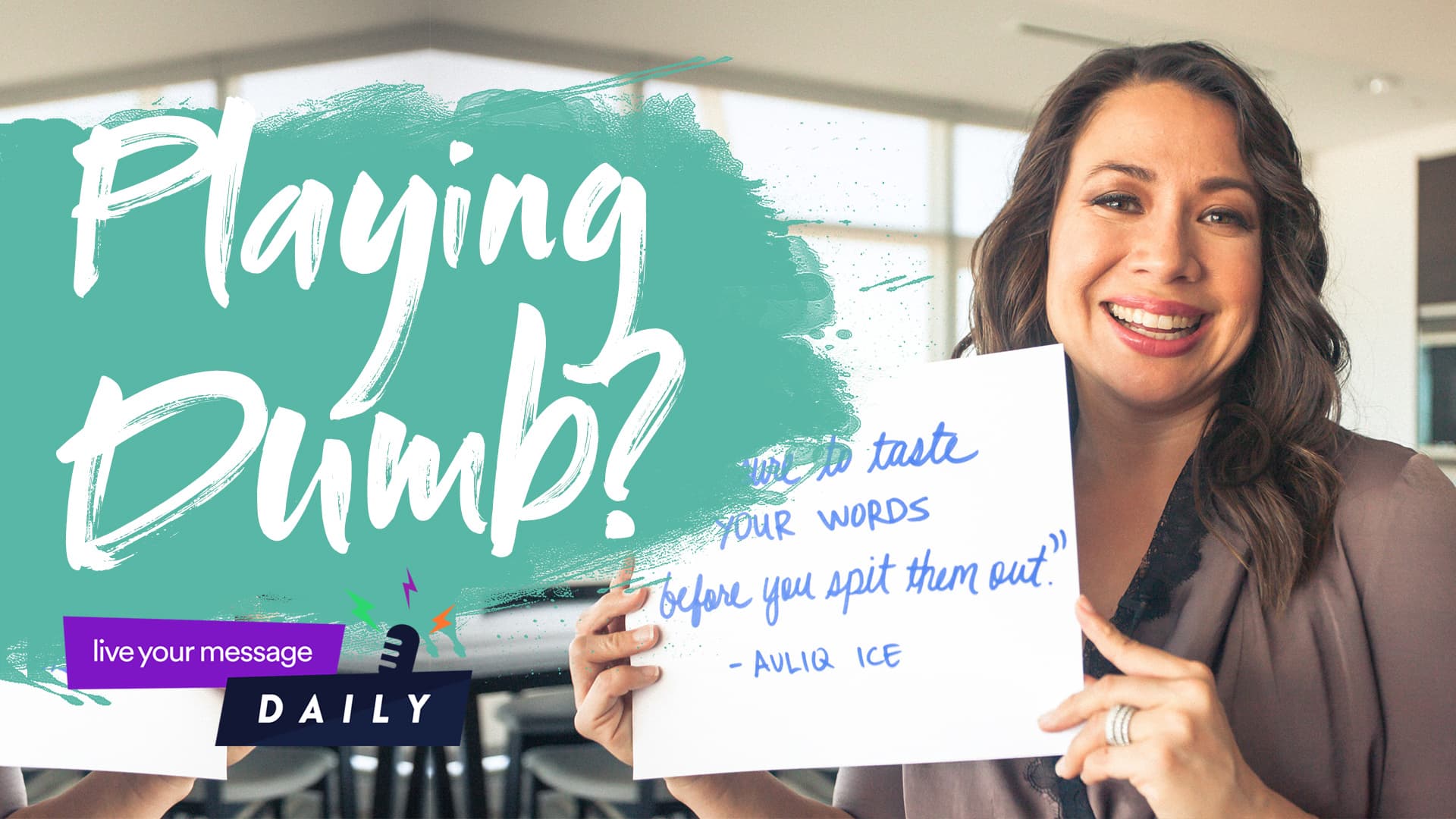 A woman smiling holds a sign with handwritten text: Taste your words before you spit them out. The background features the phrase Playing Dumb? in large, artistic font, and a small banner reads live your message DAILY.