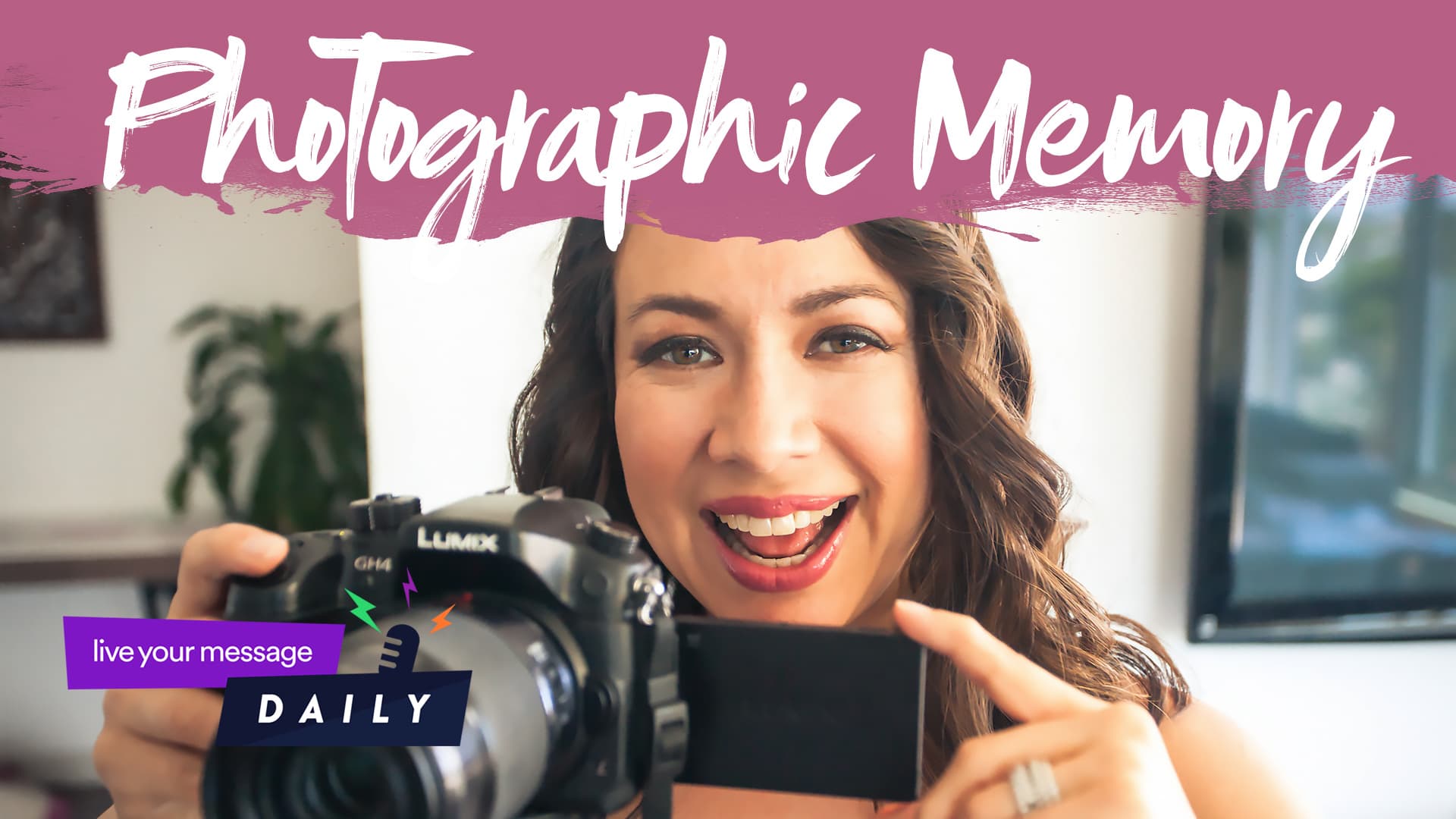 Smiling woman holding a Lumix camera, pointing at its screen. Photographic Memory is written at the top in stylized text. A small purple label in the corner reads live your message DAILY. A plant is in the background.