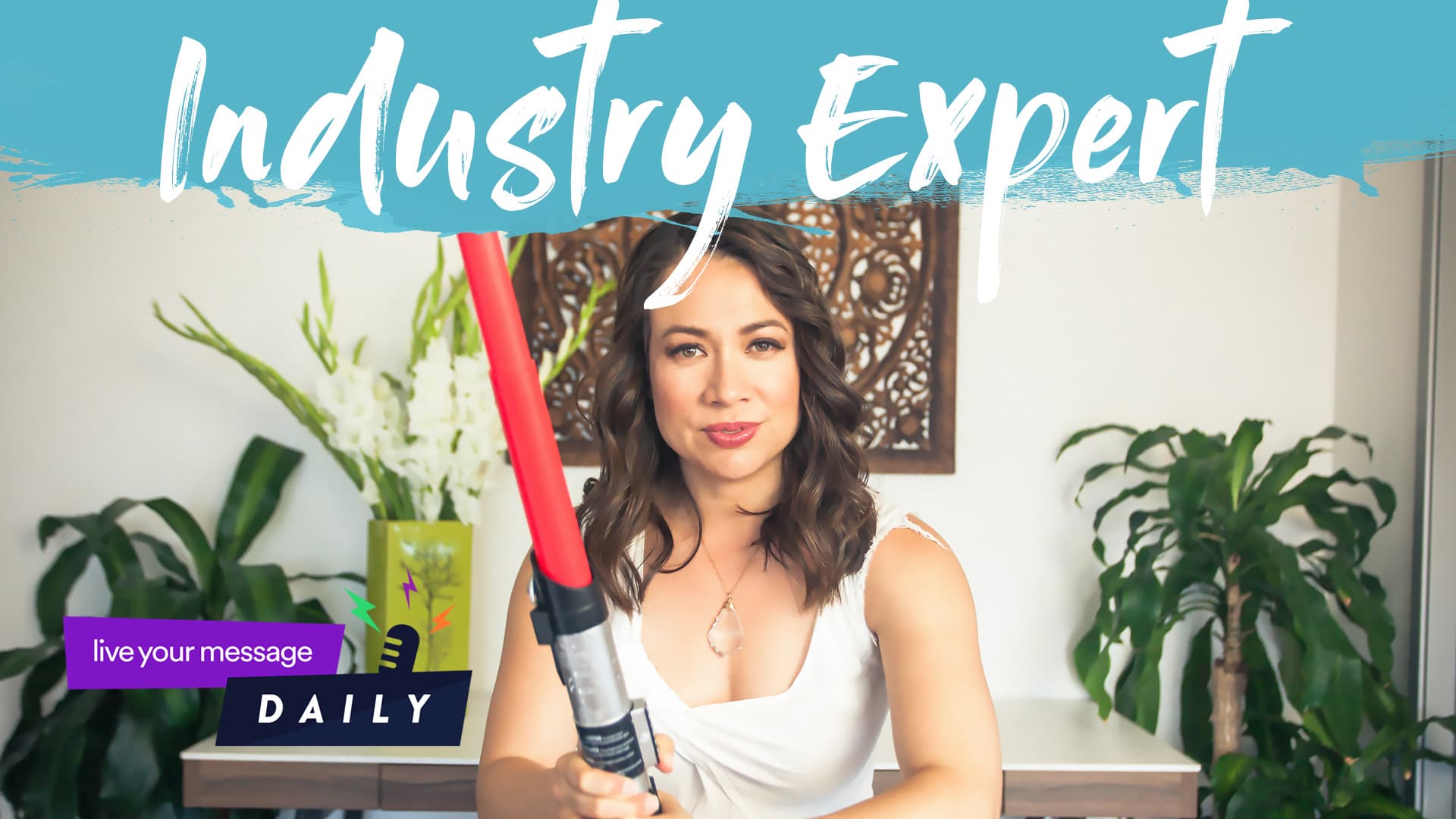 A woman in a white top holds a red lightsaber toy while sitting indoors. The room is decorated with plants and a decorative panel on the wall. The text on the image says, Industry Expert and live your message DAILY.