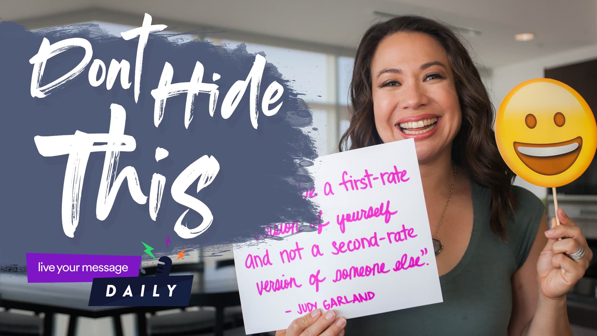 A woman smiles while holding a smiley face cutout and a handwritten note. The message on the note is about being a first-rate version of yourself. The background text reads, Dont Hide This.