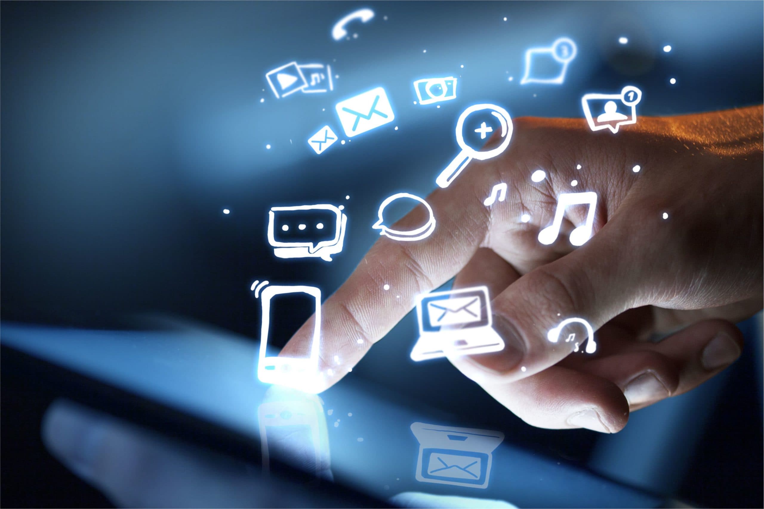A hand interacting with a touchscreen, emitting digital icons like a phone, envelope, music note, magnifying glass, and chat bubble. The scene signifies technology and communication in a dynamic digital space.
