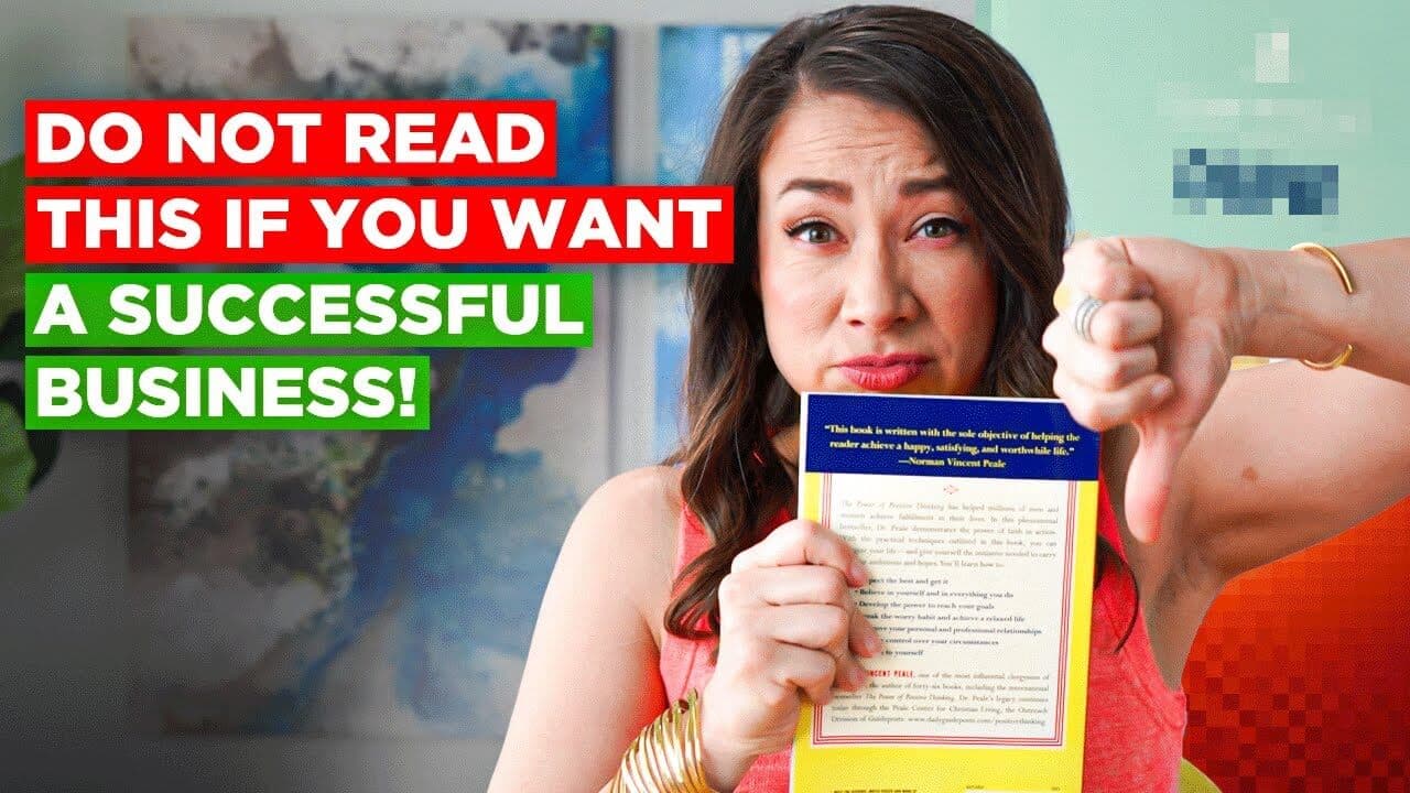 A woman holds a book with a mix of curiosity and skepticism. Text on the left reads, DO NOT READ THIS IF YOU WANT A SUCCESSFUL BUSINESS! She gives a thumbs down with her other hand, standing in a colorful room.