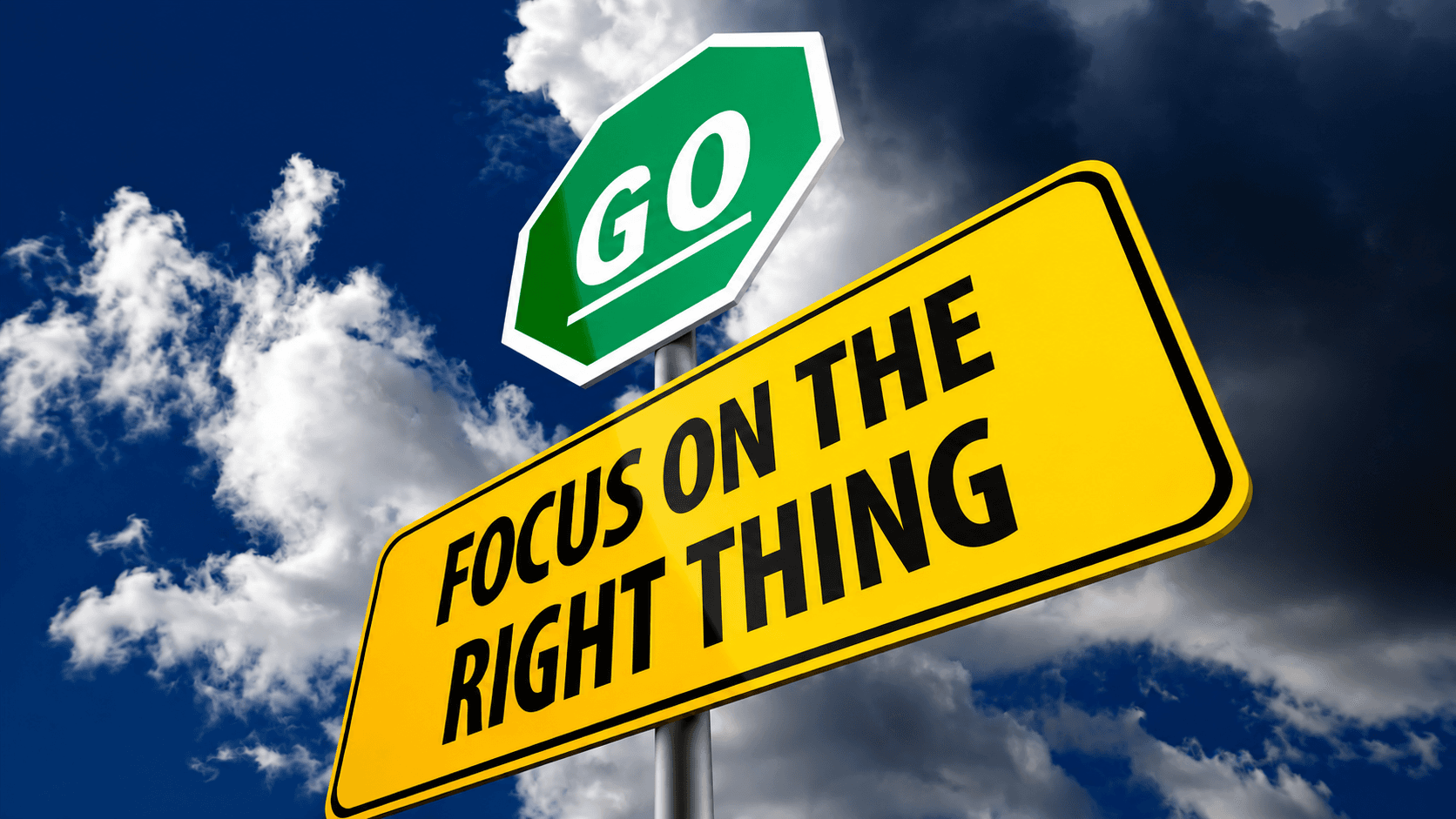 A yellow street sign reads Focus on the Right Thing below a green stop sign-shaped sign that says GO, with a cloudy blue sky in the background.