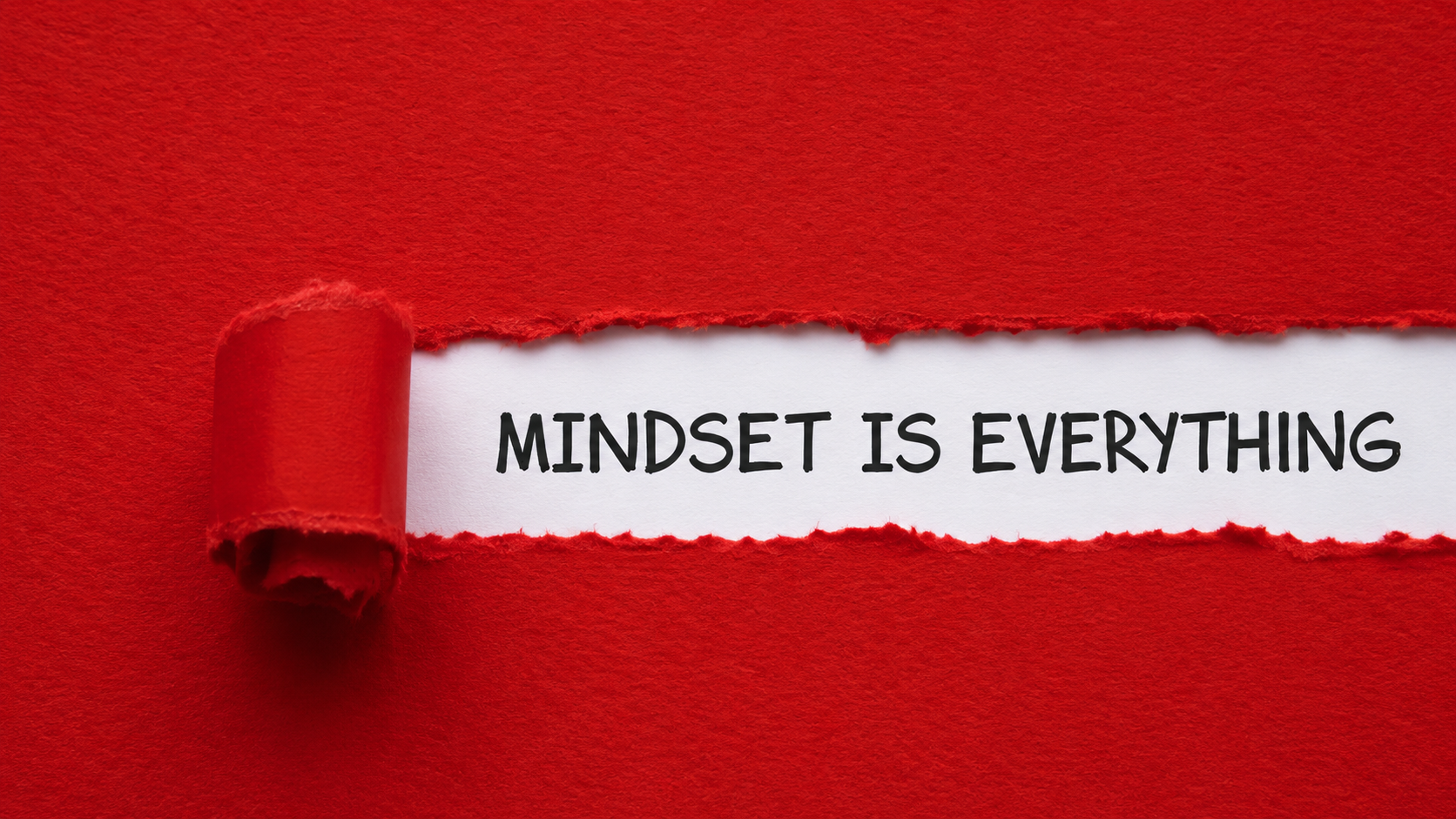 A red paper is torn back, revealing white underneath with the words MINDSET IS EVERYTHING written in bold black letters.